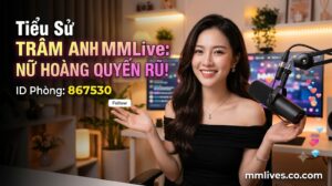 Banner hồ sơ idol Trâm Anh MMLive, giới thiệu 'Nữ hoàng quyến rũ!' với ID phòng 867530. Hình ảnh một nữ streamer trẻ mỉm cười trước thiết bị livestream, với các biểu tượng trái tim và kim cương bay lên. Bao gồm domain giacomoalonzi.io.
